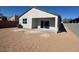 A view of the rear of a home with a patio and a dirt-covered yard at 1419 W Hess Ave, Coolidge, AZ 85128