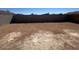 Large, empty backyard surrounded by a tall block wall, ready for landscaping at 1419 W Hess Ave, Coolidge, AZ 85128