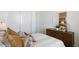 Bedroom with a queen bed and wood dresser, neutral decor at 1419 W Hess Ave, Coolidge, AZ 85128