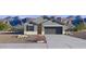 Single-story home with gray exterior, two-car garage, and landscaping at 1419 W Hess Ave, Coolidge, AZ 85128