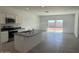 Open kitchen features granite countertops, an island with a sink, and sliding glass doors at 1419 W Hess Ave, Coolidge, AZ 85128