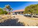 Landscaped backyard with mature trees and patio at 14607 W Sky Hawk Dr, Sun City West, AZ 85375