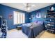 Bedroom with a full-size bed and blue walls at 14607 W Sky Hawk Dr, Sun City West, AZ 85375