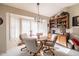 Charming dining area with wood table and built-in shelving at 14607 W Sky Hawk Dr, Sun City West, AZ 85375