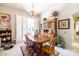 Charming dining room with wooden table and hutch at 14607 W Sky Hawk Dr, Sun City West, AZ 85375
