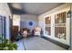 Covered front porch with seating for two at 14607 W Sky Hawk Dr, Sun City West, AZ 85375