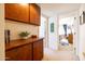 Hallway with built-in wooden cabinets and shelves at 14607 W Sky Hawk Dr, Sun City West, AZ 85375