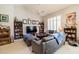 Cozy living room featuring a sectional sofa and a large TV at 14607 W Sky Hawk Dr, Sun City West, AZ 85375