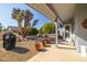 Covered patio with seating and desert landscaping at 14607 W Sky Hawk Dr, Sun City West, AZ 85375