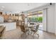 Bright breakfast nook with glass table and four chairs, adjacent to kitchen at 15511 W Agua Linda Ln, Surprise, AZ 85374