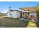 A covered back patio with lounge seating with a grassy yard at 1632 E Maryland Ave, Phoenix, AZ 85016