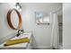 Bright bathroom features a sleek vanity with round mirror, modern fixtures, and a walk-in shower at 1632 E Maryland Ave, Phoenix, AZ 85016