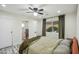 Bright bedroom featuring hardwood floors, a ceiling fan, and a window with views of lush foliage at 1632 E Maryland Ave, Phoenix, AZ 85016