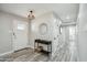 Bright entryway with wood-look tile flooring, decorative mirror, and white doors at 1632 E Maryland Ave, Phoenix, AZ 85016