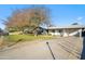 Spacious single-story home with a long driveway and mature tree in the front yard at 1632 E Maryland Ave, Phoenix, AZ 85016