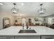 Kitchen island with stainless steel sink, pendant lighting and open concept living area at 1632 E Maryland Ave, Phoenix, AZ 85016