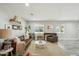 Bright living room with hardwood floors, comfortable seating, and natural light from large windows at 1632 E Maryland Ave, Phoenix, AZ 85016