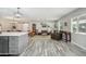 Bright, open-concept living space with wood-look tile and cozy furnishings at 1632 E Maryland Ave, Phoenix, AZ 85016