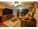 Cozy living room featuring a sectional sofa, large TV, and wood-look floors at 17241 N 16Th Dr # 10, Phoenix, AZ 85023