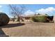 Large backyard with gravel, mature trees, and a patio area at 17607 N Foothills Dr, Sun City, AZ 85373