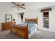 Spacious bedroom with a wooden bed frame and ceiling fan at 17607 N Foothills Dr, Sun City, AZ 85373