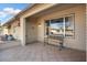 Covered patio with tiled flooring, a bench, and access to the front door at 17607 N Foothills Dr, Sun City, AZ 85373