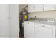 Laundry area with cabinets and water heater at 17607 N Foothills Dr, Sun City, AZ 85373