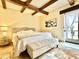 This bright primary bedroom boasts wood beam ceilings and access to a private outdoor area at 18805 E Loredo Ln, Rio Verde, AZ 85263