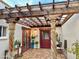 Charming courtyard featuring a wooden pergola, brick-paved ground, and rustic carved pillars at 18805 E Loredo Ln, Rio Verde, AZ 85263