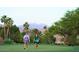 Golfers walking on a lush green golf course with mountain views at 18805 E Loredo Ln, Rio Verde, AZ 85263