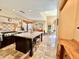 Well appointed kitchen with a large center island, stone floors and plenty of natural light creates a warm and inviting space at 18805 E Loredo Ln, Rio Verde, AZ 85263