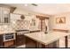 Gourmet kitchen featuring custom tile work, light countertops and an oversized island, with stainless steel appliances at 18805 E Loredo Ln, Rio Verde, AZ 85263