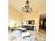 Bright living room boasts a decorative chandelier, neutral color palette and stylish furniture over stone flooring at 18805 E Loredo Ln, Rio Verde, AZ 85263