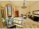 Spacious living room features a large arched window, stone floors, and stylish furnishings creating an elegant living space at 18805 E Loredo Ln, Rio Verde, AZ 85263