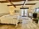 Bright main bedroom with beamed ceilings, stone floors, and a light color palette creates a warm and inviting atmosphere at 18805 E Loredo Ln, Rio Verde, AZ 85263