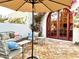 Cozy patio with comfortable seating, shade umbrella, and vibrant bougainvillea accents at 18805 E Loredo Ln, Rio Verde, AZ 85263
