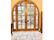 Arched glass doors leading to a patio with a view of an outdoor seating area at 18805 E Loredo Ln, Rio Verde, AZ 85263