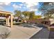 Landscaped backyard with patio, fireplace, and grassy area at 20089 N 263Rd Dr, Buckeye, AZ 85396