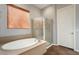 Bathroom featuring a soaking tub, shower, and tile flooring at 20089 N 263Rd Dr, Buckeye, AZ 85396