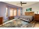 Main bedroom with wood accents, large windows, and ceiling fan at 20089 N 263Rd Dr, Buckeye, AZ 85396