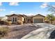 Single-story home with a two-car garage and desert landscaping at 20089 N 263Rd Dr, Buckeye, AZ 85396