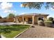 Back of house with solar panels, covered patio, and landscaped yard at 20089 N 263Rd Dr, Buckeye, AZ 85396