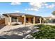 Back of house with solar panels, covered patio, and grassy yard at 20089 N 263Rd Dr, Buckeye, AZ 85396