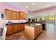 Open kitchen with granite countertops, wood cabinets, and island at 20089 N 263Rd Dr, Buckeye, AZ 85396