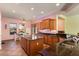 Eat-in kitchen with granite counters, island, and wood cabinets at 20089 N 263Rd Dr, Buckeye, AZ 85396