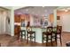 Kitchen with granite countertops, wooden cabinets and island with seating at 20089 N 263Rd Dr, Buckeye, AZ 85396