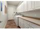 Laundry room with white cabinets and tile flooring at 20089 N 263Rd Dr, Buckeye, AZ 85396