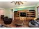 Living room featuring a rustic entertainment center and comfy seating at 20089 N 263Rd Dr, Buckeye, AZ 85396
