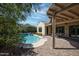 View of the backyard pool with covered patio and lush landscaping at 20369 N 272Nd Ave, Buckeye, AZ 85396