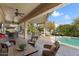 Backyard covered patio with a table overlooking a swimming pool at 20369 N 272Nd Ave, Buckeye, AZ 85396